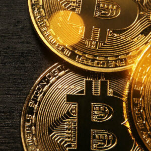 Gold bitcoins on brown background