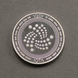 Silver IOTA coin on gray background